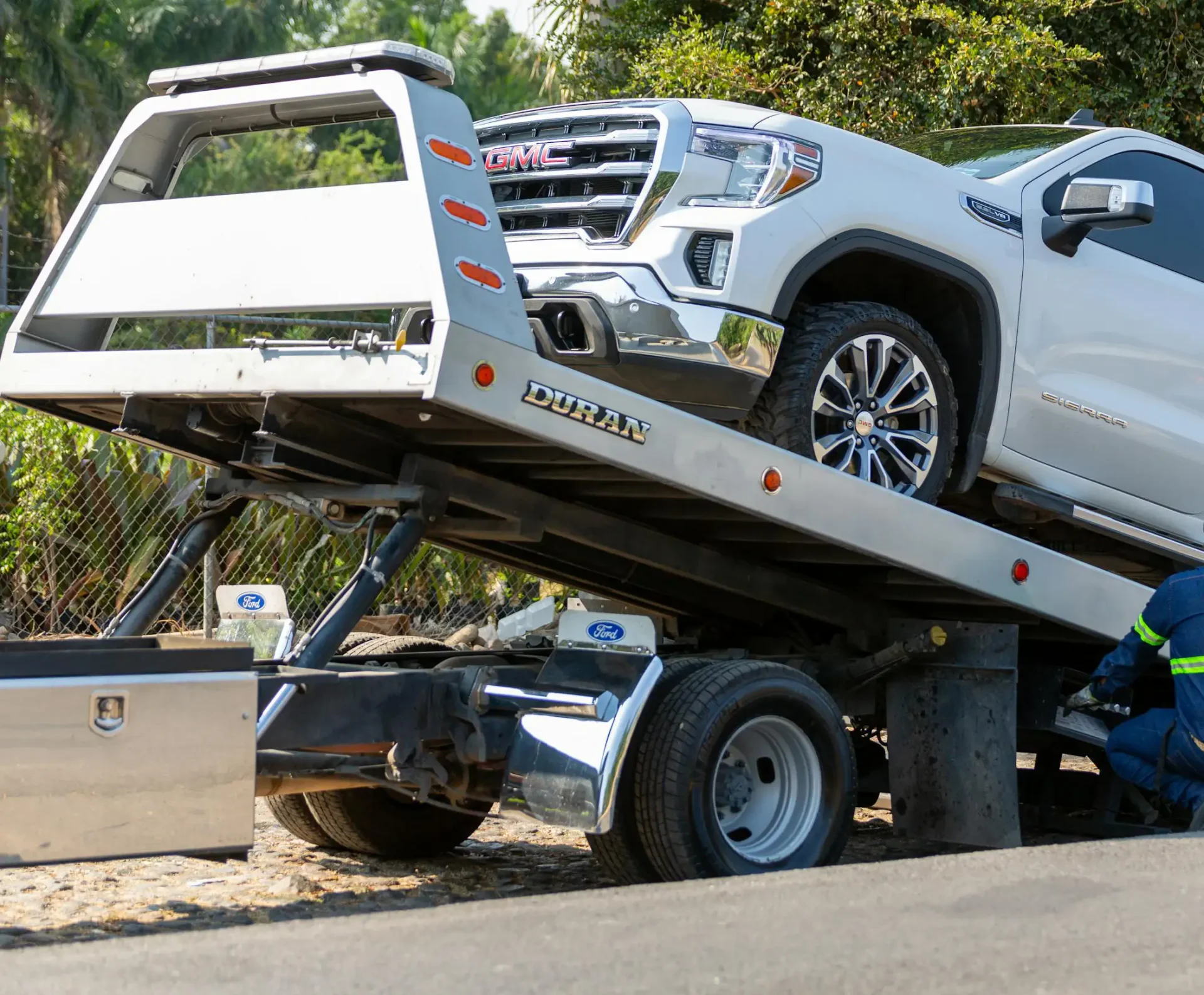 white pickup loaded on tow truck